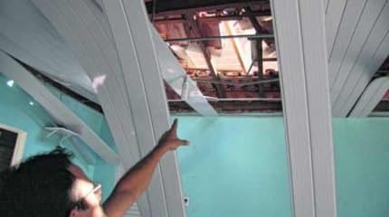 Proprietário do salão mostra para a reportagem estragos na estrutura do imóvel provocados pelo vendaval de domingo (19)