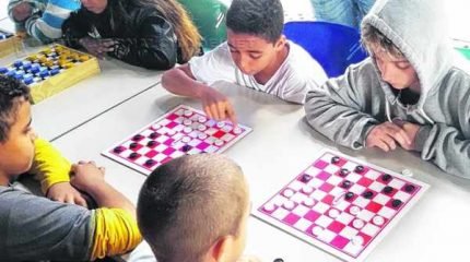 Crianças jogam damas na Olimpíada Ambiental, que intensificou atividades neste mês