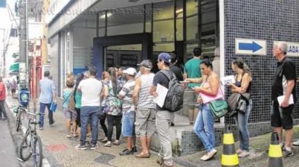 Uma imensa fila se formou na porta da agência da Caixa Econômica Federal na manhã dessa terça-feira (27), primeiro dia de atendimento após o fim da greve